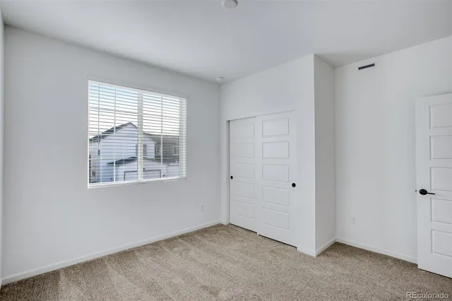 an empty room with closet area