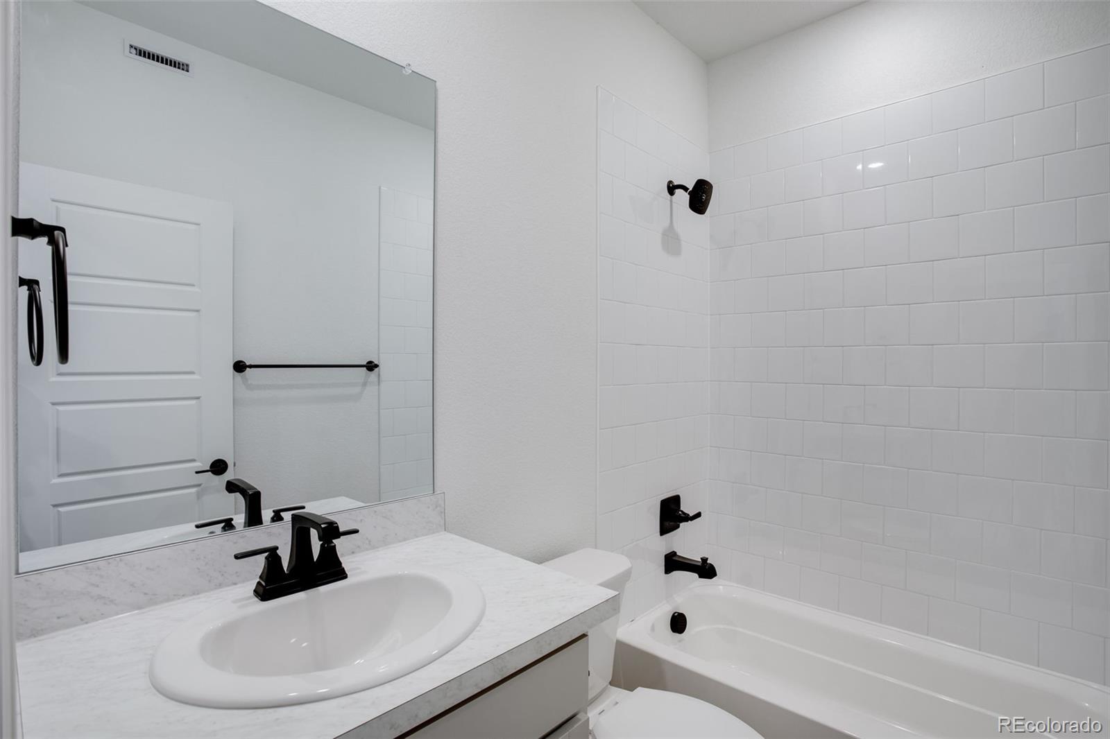 1765 Mount Meeker Avenue Berthoud, CO 80513 - Photo 30 of 37 a bathroom with a sink a toilet and shower