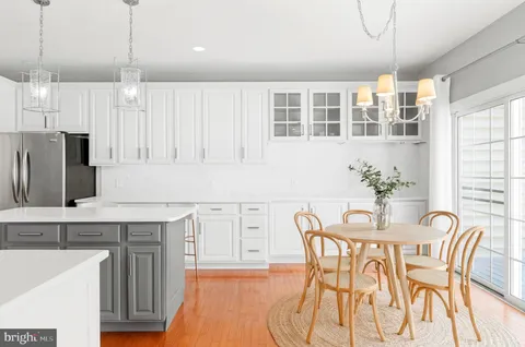 a view of a kitchen with a table and chairs