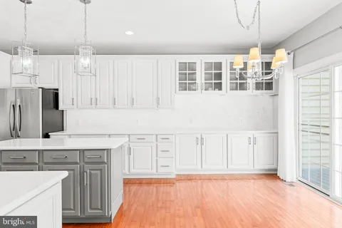 a view of kitchen with wooden floor and electronic appliances