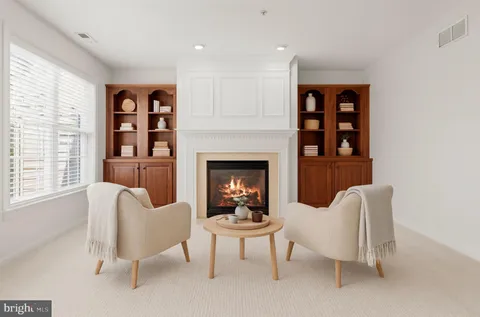 a view of an empty room with a fireplace and a window