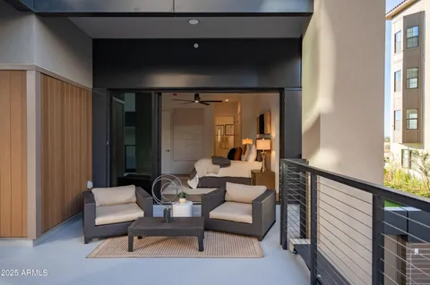 a balcony with furniture and a potted plant