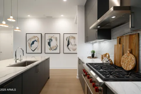 a kitchen with kitchen island granite countertop a sink and stove