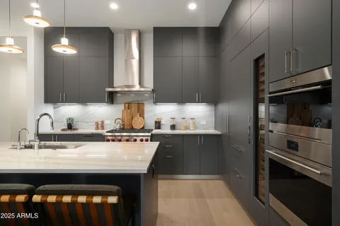 a kitchen with stainless steel appliances a sink stove and cabinets