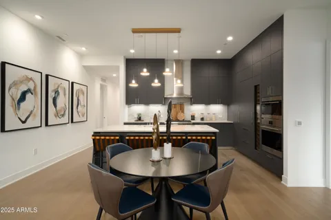 a kitchen with stainless steel appliances a sink and a refrigerator