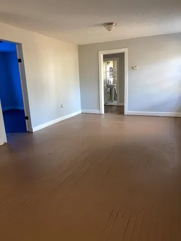 a view of a livingroom with an empty space and a window