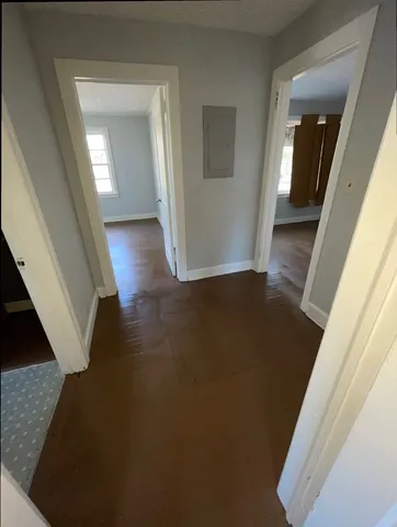 a view of a hallway view with wooden floor and staircase