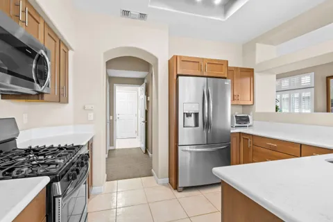 a kitchen with stainless steel appliances granite countertop a refrigerator stove and sink