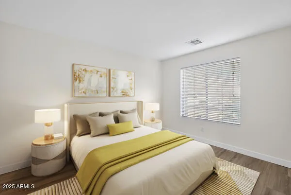 a bedroom with a bed and a painting on the wall