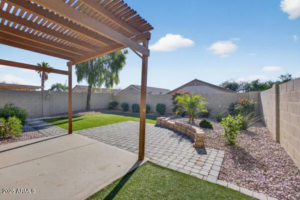 a view of a backyard with table and chairs potted plants