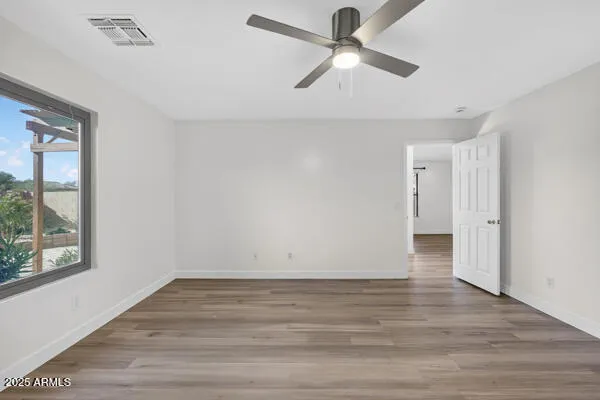 wooden floor in an empty room with a window