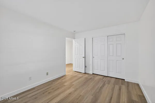 a view of an empty room and wooden floor