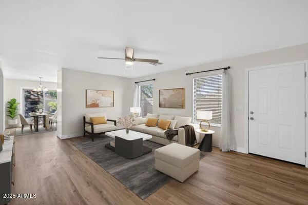 a living room with furniture and wooden floor
