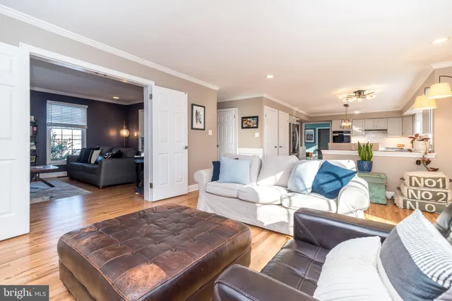 a dining room with furniture a chandelier and wooden floor