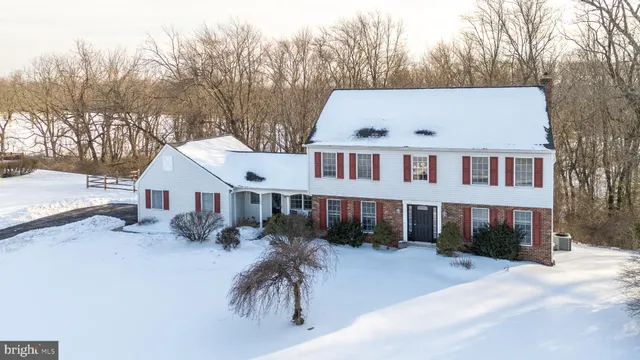 an aerial view of house with yard and trees in the background