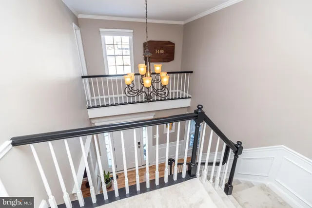 a living room with furniture a flat screen tv and a book shelf