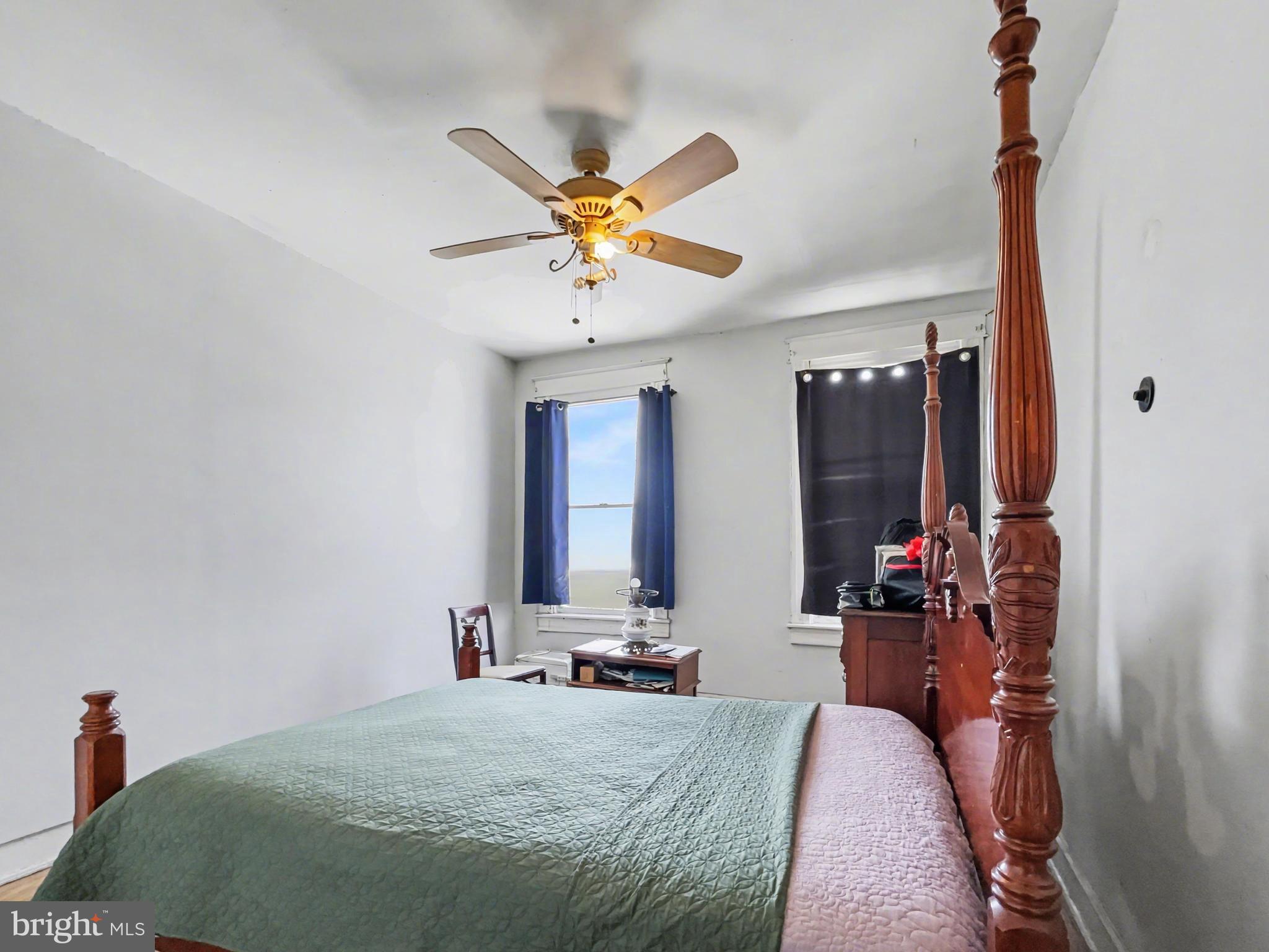 621 Edgewood Street Baltimore, MD 21229 - Photo 8 of 15 a bedroom with a bed and a chandelier