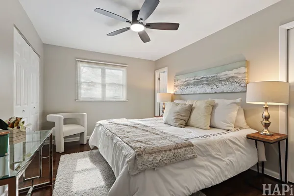 a bedroom with a large bed and a chandelier