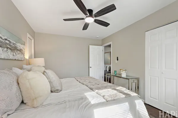 a bedroom with a bed and a large window