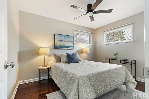 a bedroom with a bed and a painting on the wall