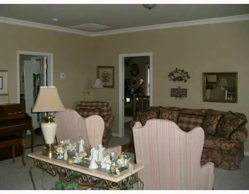 a living room with furniture and a dining table