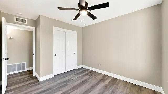 a view of a hallway with a chandelier fan