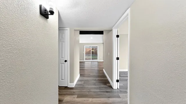 a view of a livingroom with wooden floor and a fireplace