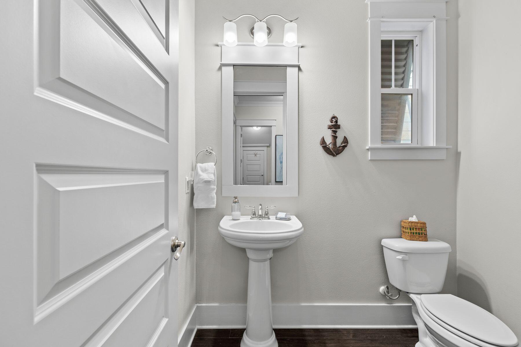 175 Milestone Drive, Unit A Inlet Beach, FL 32461 - Photo 17 of 22 a bathroom with a sink toilet and a mirror