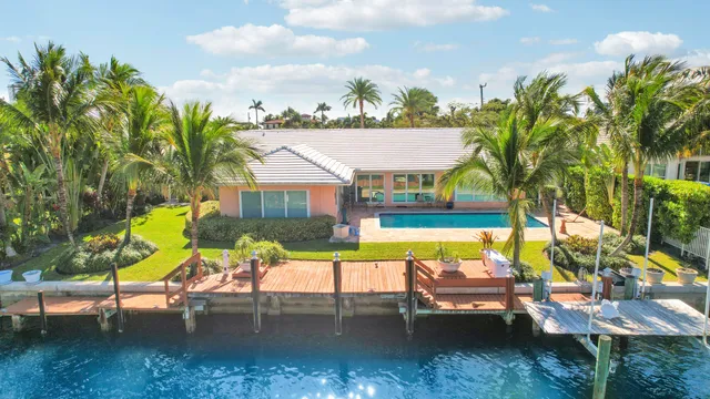 an aerial view of a house with swimming pool garden and patio