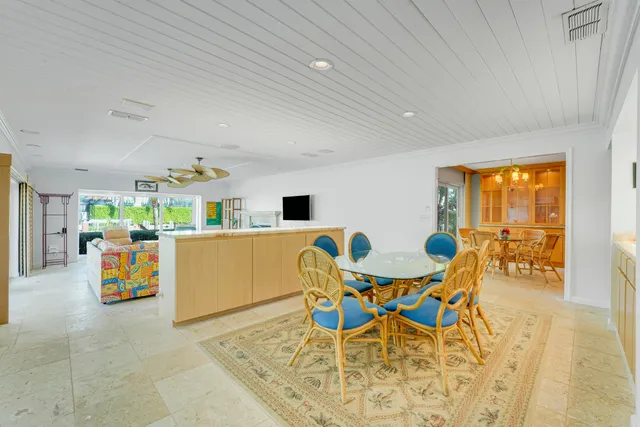 a view of a dining room with furniture and a window