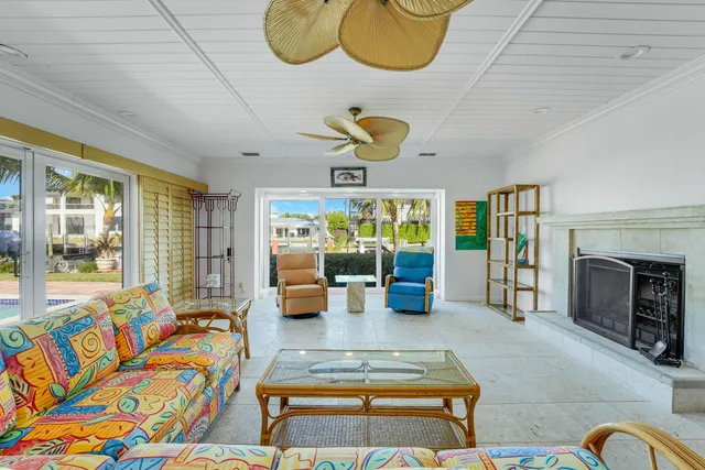 a living room with furniture fireplace and a large window