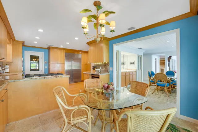 a kitchen with a sink a counter top space stainless steel appliances cabinets and a large window