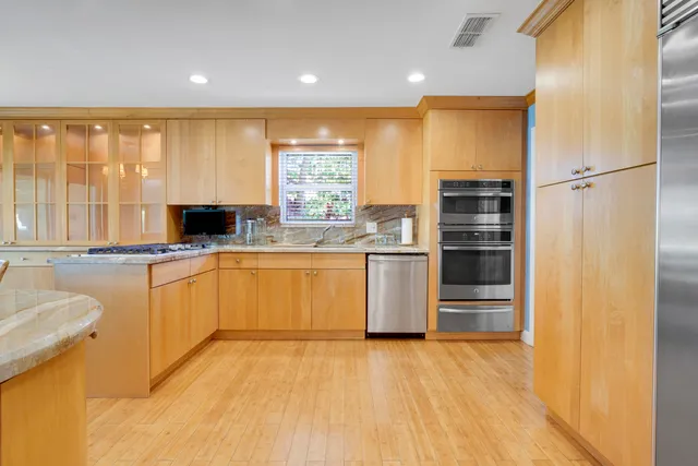 a kitchen with stainless steel appliances granite countertop a stove and a sink