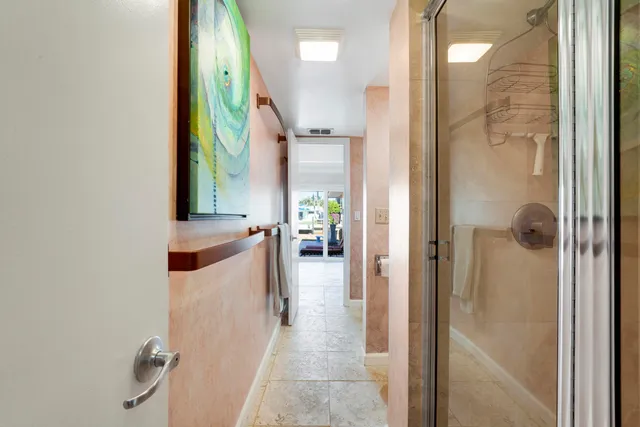 a en suite bathroom with a granite countertop sink and a mirror