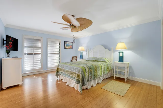 a bedroom with a bed and flat screen tv