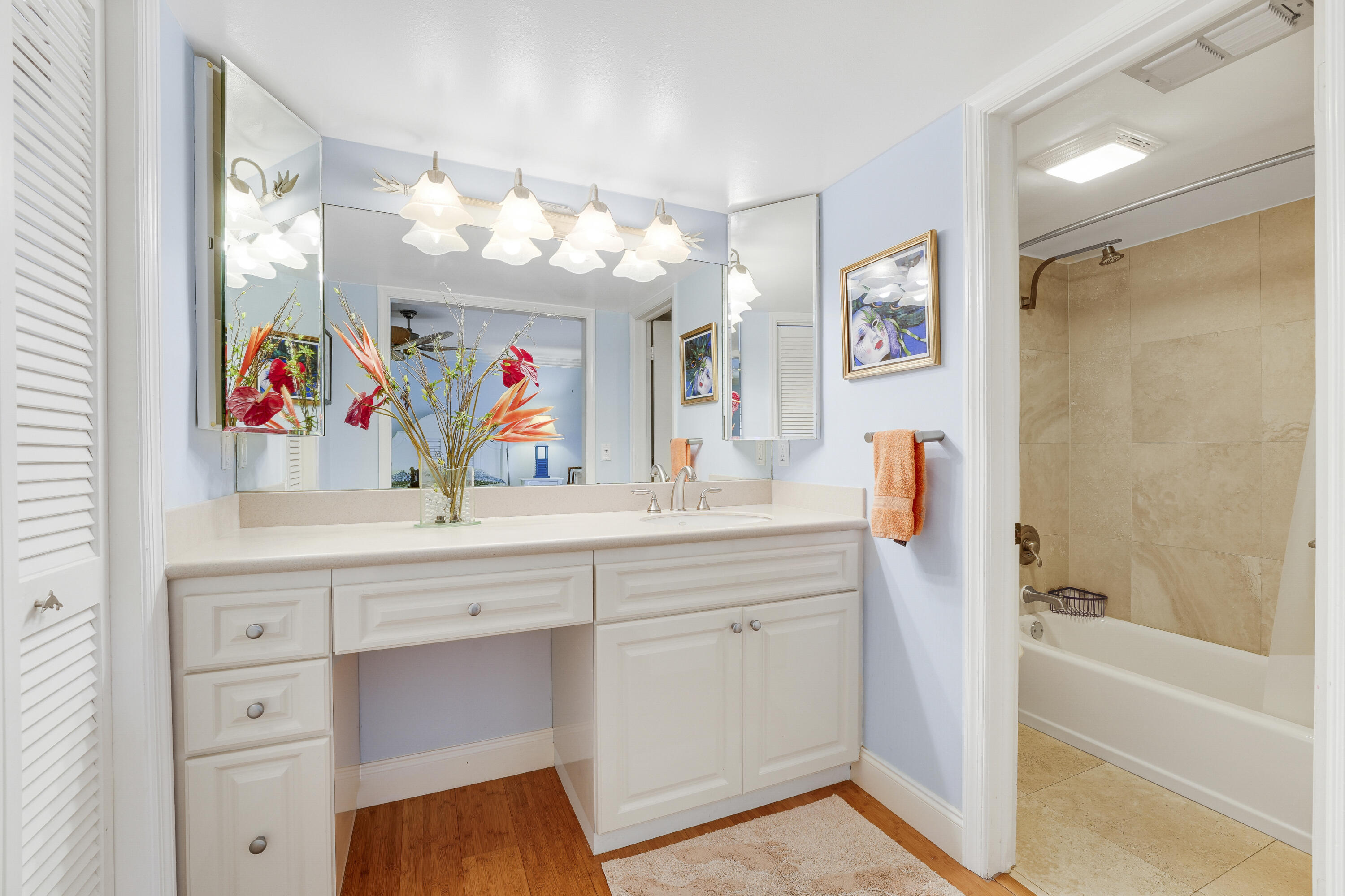 1080 Fairview Lane Singer Island, FL 33404 - Photo 41 of 51 a bathroom with a sink a vanity a mirror a bathtub and shower