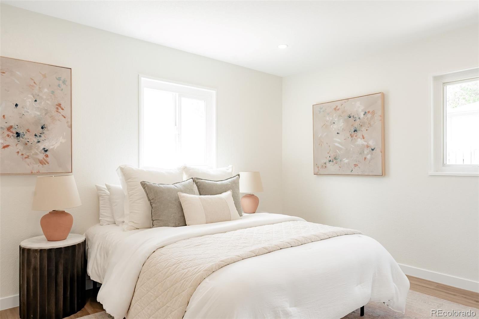 1279 South Raritan Street Denver, CO 80223 - Photo 13 of 25 a bedroom with a bed and a painting on the wall