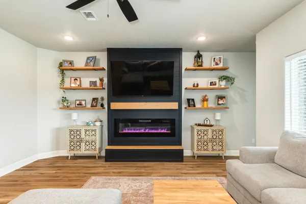 a living room with furniture and a flat screen tv