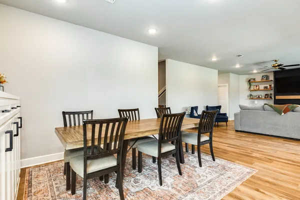 a bedroom with a bed and a chandelier fan