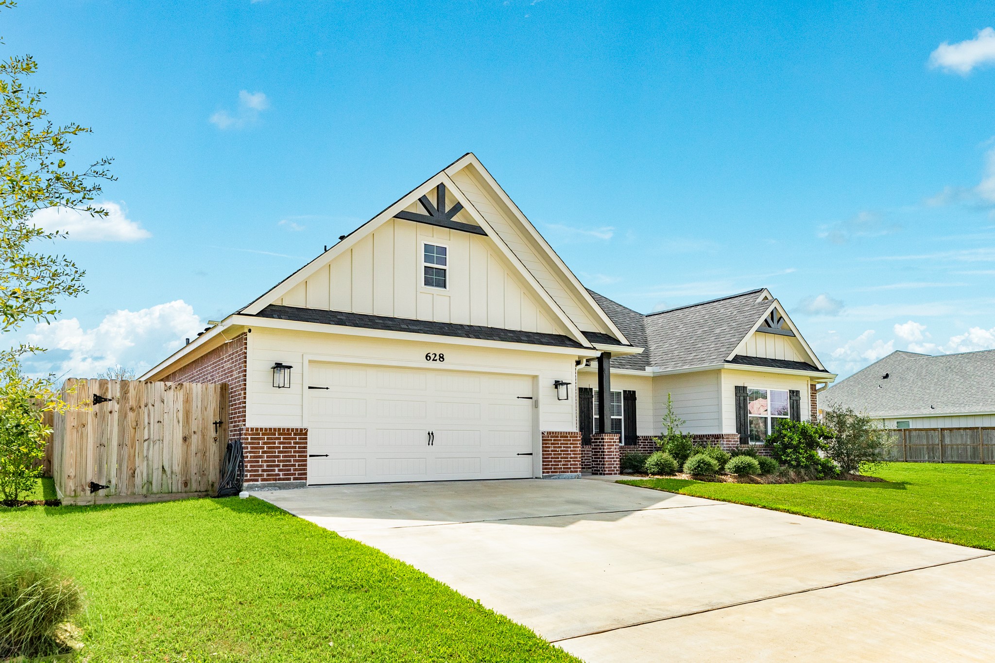 628 Greystone Lane Angleton, TX 77515 - Photo 2 of 33 a view of a white house next to a yard and a large tree
