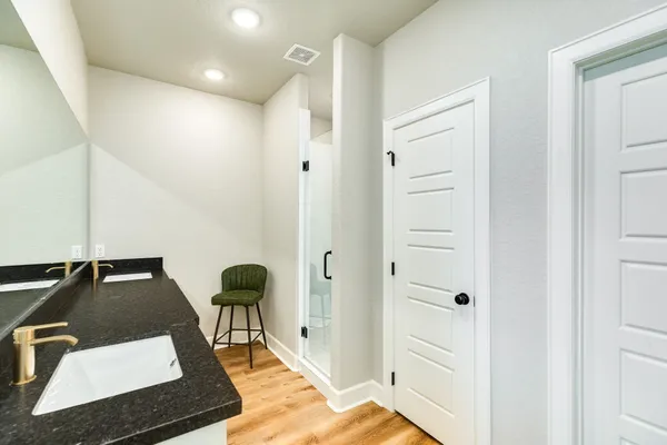 a bathroom with a granite countertop sink a toilet and bathtub
