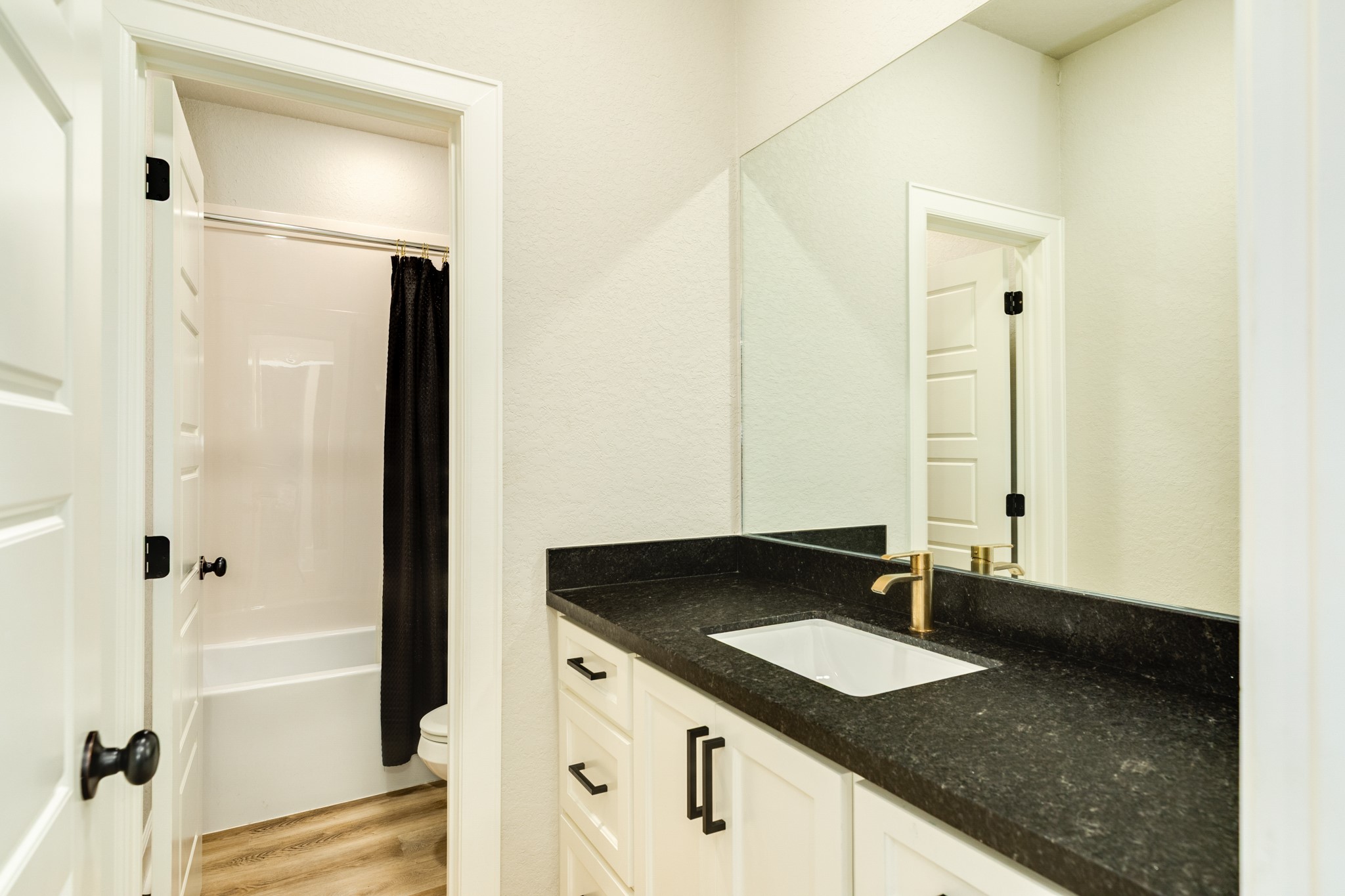 628 Greystone Lane Angleton, TX 77515 - Photo 32 of 33 a bathroom with a granite countertop sink and a mirror