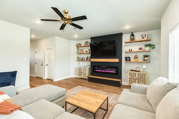 a living room with furniture and a fireplace