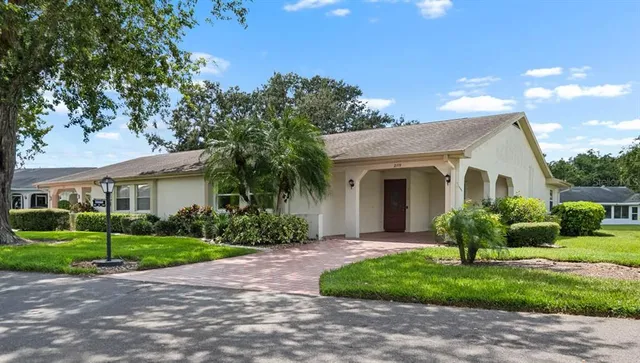 a front view of a house with garden and porch