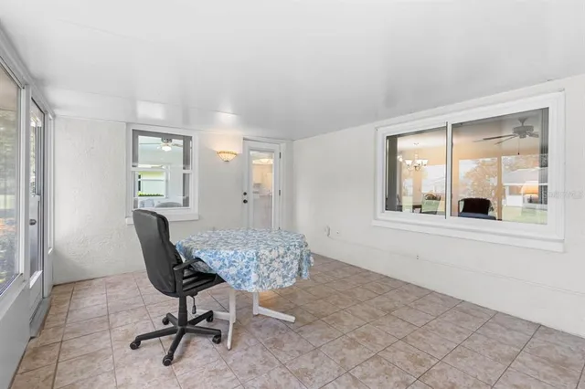 a view of a room that has a window and chair