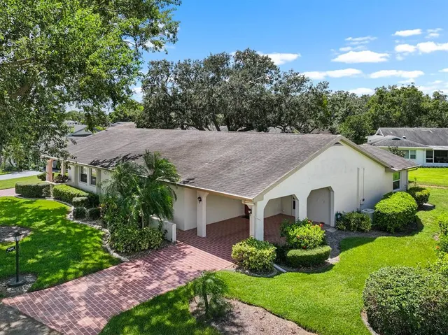 a aerial view of a house with a yard and plants