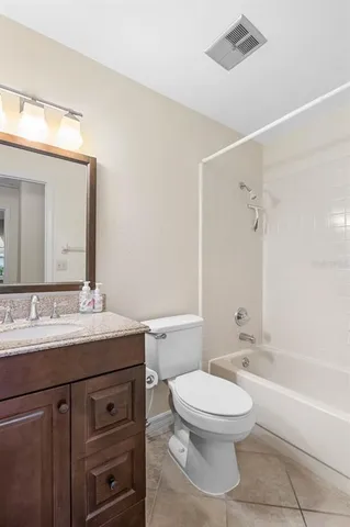 a bathroom with a toilet a sink a mirror and a bathtub