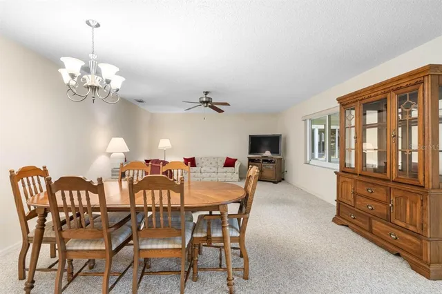 a view of a dining room with furniture chandelier and a chandelier
