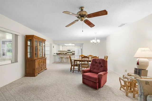 a living room with furniture and kitchen view