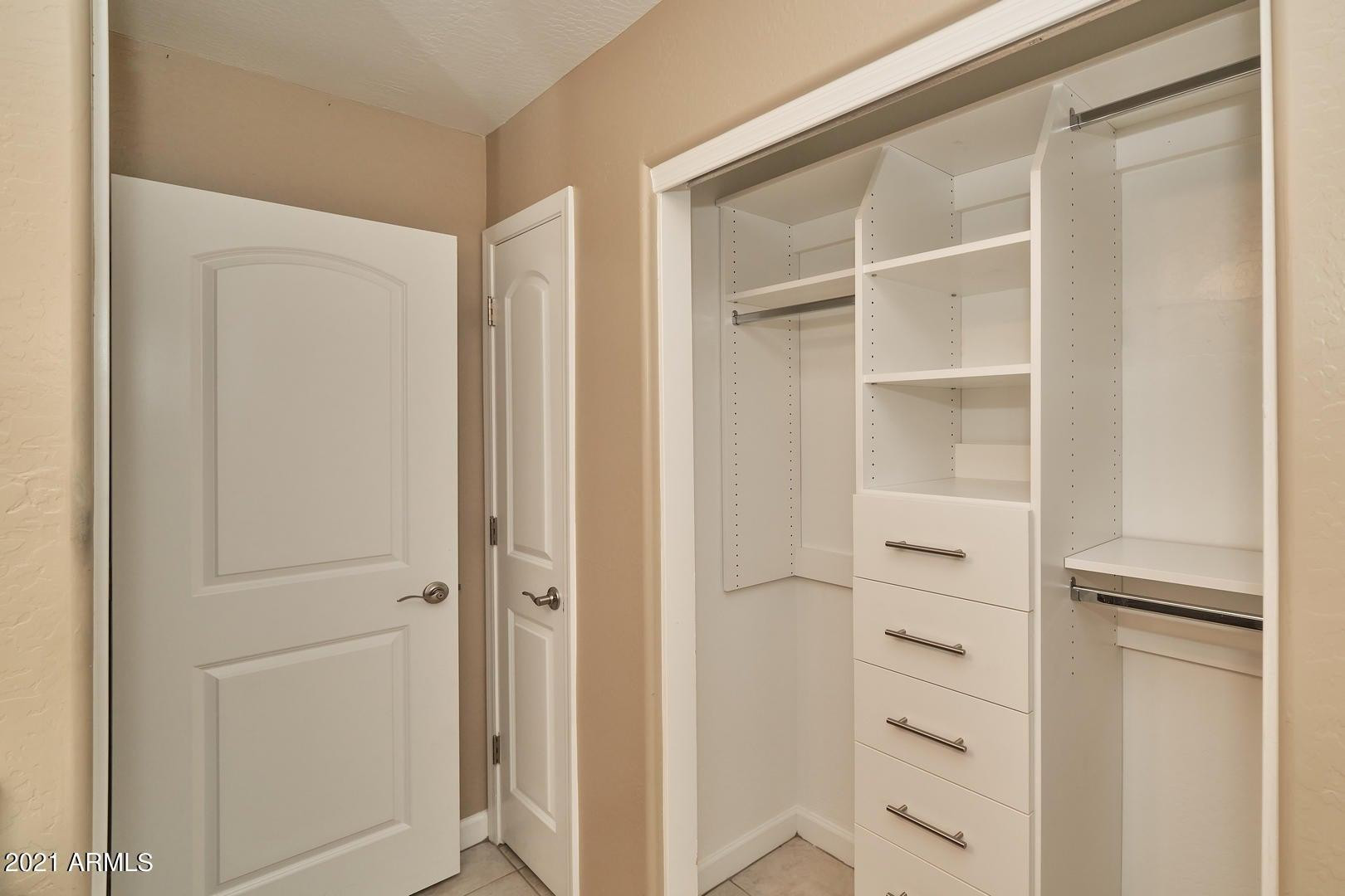 240 West Juniper Avenue, Unit 1089 Gilbert, AZ 85233 - Photo 17 of 24 a view of walk in closet with empty racks